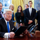 President Donald Trump on Jan. 24, 2017, in the Oval Office of the White House in Washington, D.C. Behind him are former White House chief of staff Reince Priebus, counselor to the president Kellyanne Conway, soon-to-be-former White House Communications Director Hope Hicks, maybe soon-to-be-former senior adviser Jared Kushner (second from right) and former senior counselor Stephen Bannon.
